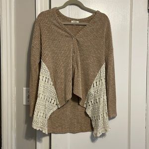 High low sweater with button up front and lace details on side. Size S